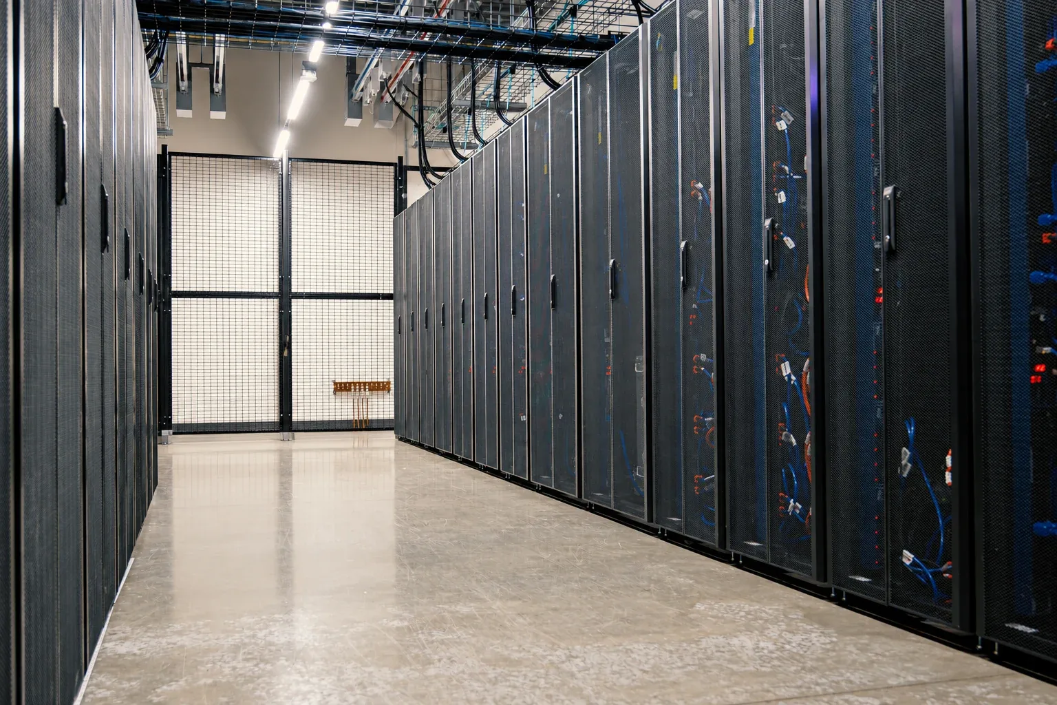 Corporate datacenter aisle with rows of closed server cabinets